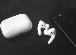 White wireless earbuds and charging case